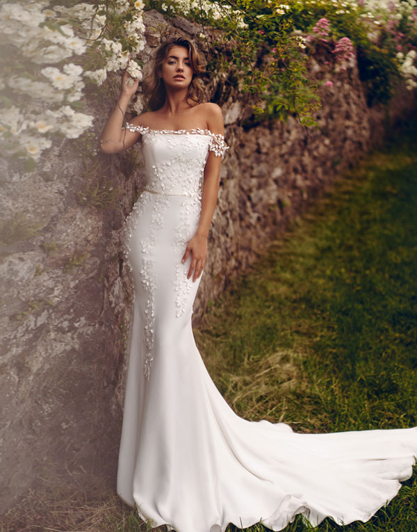 Monroe is one of our show stoppers. With it's incredible silhouette and its soft crepe fabric, what's not to love?!  The pretty petal neckline detail adds a real softness and feminity to the straight across design and the train adds drama to an already memorable dress!